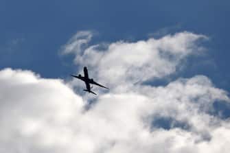 Airplane flying in the sky. Silhouette of a passenger plane taking off on background of storm clouds