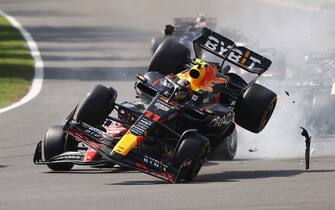 AUTODROMO HERMANOS RODRIGUEZ, MEXICO - OCTOBER 29: Charles Leclerc, Ferrari SF-23, and Sergio Perez, Red Bull Racing RB19, make contact at the start causing the Mexican to crash out during the Mexico City GP at Autodromo Hermanos Rodriguez on Sunday October 29, 2023 in Mexico City, Mexico. (Photo by Andy Hone / LAT Images)
