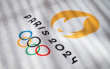 PARIS, FRANCE, MARCH 26, 2024: The Official Logo of the Paris 2024 Summer Olympics in warm light on white towel