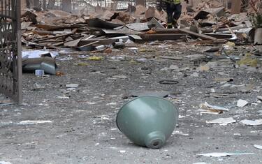 A firefighter walks among damages in a building entrance  after the shelling by Russian forces of Constitution Square in Kharkiv, Ukraine's second-biggest city, on March 2, 2022. - On the seventh day of fighting in Ukraine on March 2, Russia claims control of the southern port city of Kherson, street battles rage in Ukraine's second-biggest city Kharkiv, and Kyiv braces for a feared Russian assault. (Photo by Sergey BOBOK / AFP) (Photo by SERGEY BOBOK/AFP via Getty Images)