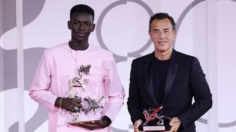 VENICE, ITALY - SEPTEMBER 09: Seydou Sarr and Matteo Garrone pose with the Marcello Mastroianni Award for Best New Young Actor or Actress and the Silver Lion for Best Director for film ‘Io Capitano’  at the winner's photocall at the 80th Venice International Film Festival on September 09, 2023 in Venice, Italy. (Photo by Andreas Rentz/Getty Images)