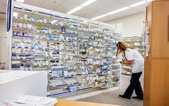 Miami Beach Florida,Walgreens pharmacy,drugstore pharmacist woman female filling prescription,employee worker working staff medicine drugs