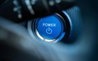 A closeup of a keyless power button for switching on a 2021 Toyota CH-R, a self charging petrol hybrid car. UK