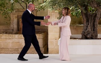 FASANO, ITALY - JUNE 13: European Council President Charles Michel (L) is greeted by Italian Prime Minister Giorgia Meloni during a welcome ceremony on day one of the 50th G7 summit at Borgo Egnazia on June 13, 2024 in Fasano, Italy. The G7 summit in Puglia, hosted by Italian Prime Minister Giorgia Meloni, the seventh held in Italy, gathers leaders from the seven member states, the EU Council, and the EU Commission. Discussions will focus on topics including Africa, climate change, development, the Middle East, Ukraine, migration, Indo-Pacific economic security, and artificial intelligence. (Photo by Christopher Furlong/Getty Images)