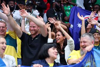 DUESSELDORF, GERMANY - SEPTEMBER 13: Prince Harry, Duke of Sussex and Meghan, Duchess of Sussex wave their hands as they attend the Wheelchair Basketball preliminary match between Ukraine and Australia during day four of the Invictus Games DÃ¼sseldorf 2023 on September 13, 2023 in Duesseldorf, Germany. (Photo by Chris Jackson/Getty Images for the Invictus Games Foundation)