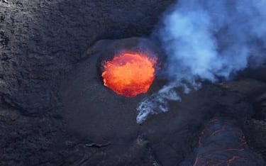 Picture taken with a drone on April 13, 2024 at Svartsengi near Grindavik, Iceland, shows an aerial view of a volcanic eruption at Sundhnukagigar in southwest Iceland, ongoing for a month. (Photo by Jeremie RICHARD / AFP) / TO GO WITH AFP STORY by Jeremie RICHARD (Photo by JEREMIE RICHARD/AFP via Getty Images)