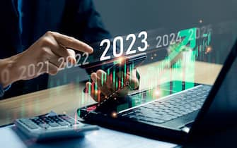 stock market trends for 2023, Businessman calculating financial data for long term investments. Analytical businessman planning business growth 2023 with future economic growth arrow graphic. strategy