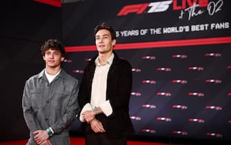 Mercedes' Italian driver Andrea Kimi Antonelli (L) and  Mercedes' British driver George Russell pose on the red carpet upon arrival for the Formula One - 2025 season launch “F1 75 LIVE” event at the O2, in London, on February 18, 2025. (Photo by HENRY NICHOLLS / AFP) / --- RESTRICTED TO EDITORIAL USE ---