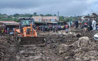 An excavator digs to search for survivors after mudslide which occurred due to heavy rains resulting from cyclone Freddy at Manje informal settlement in Blantyre, southern Malawi, on March 16, 2023. - As the rains ceased for the first time in five days, Malawi began the process of recovering bodies from cyclone Freddy-induced mudslides. (Photo by Amos Gumulira / AFP) (Photo by AMOS GUMULIRA/AFP via Getty Images)