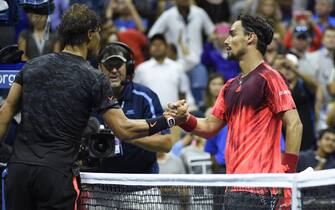 epa04914016 Fabio Fognini of Italy (R) and Rafael Nadal of Spain (L) shake hands at the net after Fognini defeated Nadal in  their match on the fifth day of the 2015 US Open Tennis Championship at the USTA National Tennis Center in Flushing Meadows, New York, USA, 04 September 2015. The US Open runs through 13 September, which is a return to a 14-day schedule.  EPA/JOHN G. MABANGLO