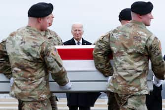 DOVER, DELAWARE - FEBRUARY 02: U.S. President Joe Biden places his hand over his heart while watching a U.S. Army carry team move a flagged draped transfer case containing the remains of Army Sgt. William Rivers during a dignified transfer at Dover Air Force Base on February 02, 2024 in Dover, Delaware. U.S. Army Sgt. William Rivers, Sgt. Breonna Moffett, and Sgt. Kennedy Sanders was killed in addition to 40 other troops who were injured during a drone strike in Jordan. (Photo by Kevin Dietsch/Getty Images)