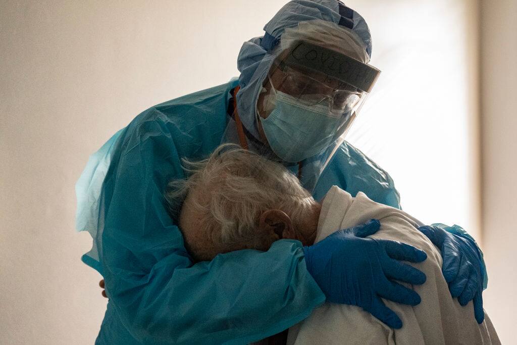 HOUSTON, TX - NOVEMBER 26: (EDITORIAL USE ONLY) Dr. Joseph Varon hugs and comforts a patient in the COVID-19 intensive care unit (ICU) during Thanksgiving at the United Memorial Medical Center on November 26, 2020 in Houston, Texas. According to reports, Texas has reached over 1,220,000 cases, including over 21,500 deaths.  (Photo by Go Nakamura/Getty Images)