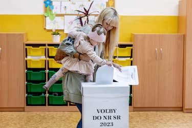 BRATISLAVA, SLOVAKIA - SEPTEMBER 30: A voter cast her ballots at a polling station as voting takes place in the Slovak parliamentary elections on September 30, 2023 in Bratislava, Slovakia. The election is pitting the socially-liberal, pro-European Progressive Slovakia party, which is in second place in pre-election polls, against SMER, currently first place in polls. SMER's lead candidate, former Slovak prime minister Robert Fico, has taken on a more pro-Russian, anti-European Union platform, including advocating an immediate halt to Slovak military aid to Ukraine. The elections are taking place following a breakdown of the governing coalition government last year.(Photo by Janos Kummer/Getty Images)