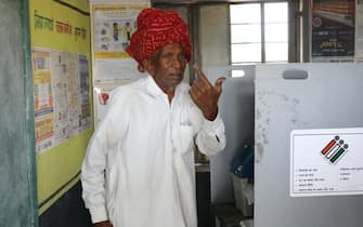 epa11287789 An Indian man shows his inked finger at a polling station after casting his vote for the first phase of the general elections, in Shahpura village, on the outskirts of Jaipur, Rajasthan, India, 19 April 2024. The Indian general elections will be held over seven phases between 19 April and 01 June 2024 with the results being announced on 04 June for the 545-member lower house of parliament, or Lok Sabha. The elections are held every five years, and about 968 million people are eligible to vote.  EPA/RAJAT GUPTA