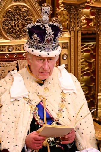 Britain's King Charles III, wearing the Imperial State Crown and the Robe of State, reads the King's speech from The Sovereign's Throne in the House of Lords chamber, during the State Opening of Parliament, at the Houses of Parliament, in London, on November 7, 2023. (Photo by Leon Neal / POOL / AFP)
