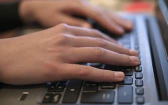 Woman hands view while using laptop for smart working,covid-19 pandemic disease