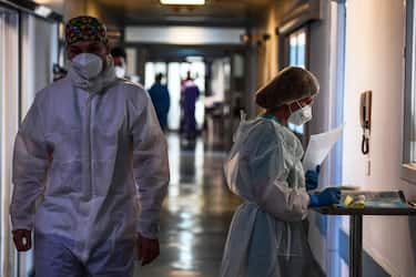 Medical staff members walk in a corridor at the Covid-19 intensive care unit of Cremona hospital, in Cremona, northern Italy, on January 11, 2022. - Italy's Prime Minister Mario Draghi put the pressure back on the unvaccinated on January 10, 2022, calling them the cause of "most of the problems" in the country, which has been plagued by the spread of the Omicron variant. (Photo by Miguel MEDINA / AFP) (Photo by MIGUEL MEDINA/AFP via Getty Images)