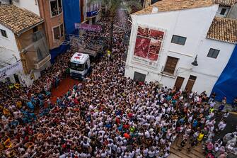 BUNOL, SPAIN - AUGUST 30: Revellers arrive at the town hall square in the back of a lorry containing tomatoes as they participate in the annual Tomatina festival on August 30, 2023 in Bunol, Spain. Spain's tomato throwing party in the streets of Bunol, Valencia brings together almost 20,000 people, with some 150,000 kilos of tomatoes thrown each year, this year with a backdrop of high food prices affected by Spain's historic drought. (Photo by Zowy Voeten/Getty Images)