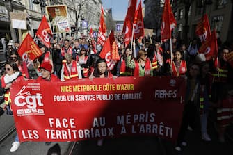epa10546810 Protesters hold flags of the General Confederation of Labour (CGT) of trade unions during a protest against government's pension reform at Nice, France, 28 March 2023. France faces an ongoing national strike against the government's pensions reform after Prime Minister Elisabeth Borne on 16 March announced the use of article 49 paragraph 3 (49.3) of the Constitution of France to have the text on the controversial pension reform law to be definitively adopted without a vote.  EPA/SEBASTIEN NOGIER