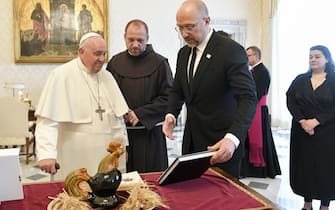 A handout picture provided by the Vatican Media shows Pope Francis (L) exchanging gifts with Ukraine's Prime Minister Denys Shmyhal (R) on the occasion of a meeting, Vatican City, 27 April 2023. ANSA/VATICAN MEDIA HANDOUT HANDOUT EDITORIAL USE ONLY/NO SALES