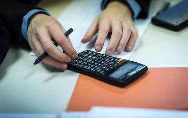 a male pupil uses a calculator during a lesson