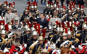 French President Emmanuel Macron (C) parades with Republican Guard cavalry officers during the Bastille Day military parade on the Champs-Elysees avenue in Paris on July 14, 2023. (Photo by Ludovic MARIN / AFP) (Photo by LUDOVIC MARIN/AFP via Getty Images)