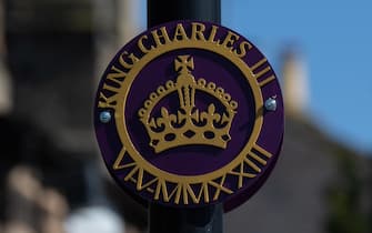 epa10580514 A purple and gold sign reading  King Charles III  and the date of the coronation hangs from a lamppost in Spofforth, Britain, 19 April 2023. King Charles III will be crowned on 06 May 2023.  EPA/ADAM VAUGHAN