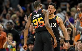PHOENIX, AZ - MAY 5: Devin Booker (1) of the Phoenix Suns celebrates with Kevin Durant (35) after hitting a corner three pointer amidst a Suns run to take a double-digit lead over the Denver Nuggets during the second quarter at Footprint Center in Phoenix on Friday, May 5, 2023. (Photo by AAron Ontiveroz/MediaNews Group/The Denver Post via Getty Images)