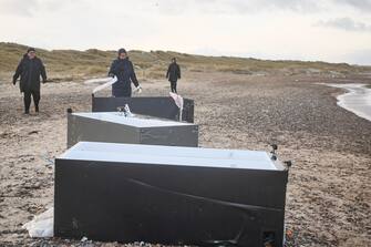 epa11044603 Locals inspect items from containers spillage  along the West coast at Tranum beach in North Jutland, Denmark, 26 December 2023. The contents of 46 lost containers from the ship Mayview Maersk wash ashore in North Jutland. The containers washed overboard during storm Pia.  EPA/Claus Bjoern Larsen  DENMARK OUT