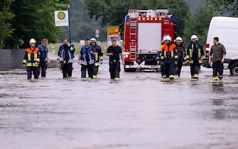 02 June 2024, Bavaria, Reichertshofen: Helpers walk across a flooded road. Photo: Sven Hoppe/dpa (Photo by Sven Hoppe/picture alliance via Getty Images)