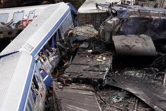 epa10496490 Destroyed train wreckege after a collision near Larissa city, Greece, 01 March 2023. The number of confirmed dead from the deadly train collision at Tempi rises to 36 on Wednesday 01 March morning as the search-and-rescue operation continues, according to the latest update from the fire brigade spokesperson Vasilis Vathrakogiannis. The number of injured in hospital increased to 66, of which six were admitted to ICUs. The search of the wreckage is ongoing, with efforts focused on the first three carriages of the passenger train which overturned, with the assistance of specialised truck-mounted cranes.  EPA/ACHILLEAS CHIRAS