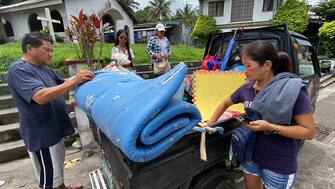 epa10684691 Villagers living at Mayon volcano s danger zone load belongings onto a vehicle during a mass evacuation in Daraga, Albay province, Philippines, 11 June 2023. The province of Albay was placed under a state of calamity due to the threat of an eruption of Mayon Volcano. The office of Civil Defense had evacuated 2,638 families in the towns of Camalig, Ligao City, Daraga, Guinobatan, Malilipot and Tabaco City.  EPA/FRANCIS R. MALASIG