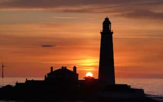The sunrises at 04.25am at St Mary's Lighthouse in Whitley Bay, on the North East coast of England, the day before Summer Solstice - the longest day of the year. Picture date: Tuesday June 20, 2023. (Photo by Owen Humphreys/PA Images via Getty Images)