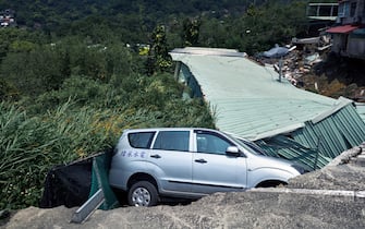 A vehicle in a collapsed road following an earthquake in New Taipei City, Taiwan, on Wednesday, April 3, 2024. Taiwan has been hit by the strongest earthquake in a quarter of a century, with shocks from the temblor leveling dozens of buildings on the eastern side of the island, injuring more than 50 people and disrupting some chip production lines. Photographer: An Rong Xu/Bloomberg