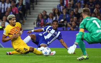 epa10900574 FC Porto's Wendell (C) in action against FC Barcelona´s Ronald Araujo during the UEFA Champions League group H match between FC Porto and FC Barcelona, in Porto, Portugal, 04 October 2023.  EPA/ESTELA SILVA