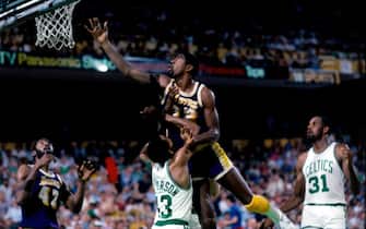 BOSTON - JUNE 12:  Magic Johnson #32 of the Los Angeles Lakers shoots a layup against Gerald Henderson #43 of the Boston Celtics during Game Seven of the 1984 NBA Finals played on June 12 at the Boston Garden in Boston, Massachusetts. The Boston Celtics defeated the Los Angeles Lakers 111-102 and won the series 4-3 to capture the 1984 NBA Championship. NOTE TO USER: User expressly acknowledges that, by downloading and or using this photograph, User is consenting to the terms and conditions of the Getty Images License agreement. Mandatory Copyright Notice: Copyright 1984 NBAE (Photo by Dick Raphael/NBAE via Getty Images)