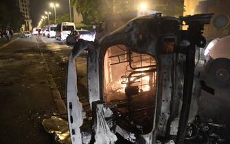 epa10718285 A car burns during clashes between protesters and riot police in Nanterre, near Paris, France, 29 June 2023. Violence broke out after police fatally shot a 17-year-old during a traffic stop in Nanterre on 27 June 2023. According to the French interior minister, 31 people were arrested with 2,000 officers being deployed to prevent further violence.  EPA/JULIEN MATTIA