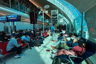 Passengers wait for their flights at the Dubai International Airport in Dubai on April 17, 2024. Dubai's major international airport diverted scores of incoming flights on April 16 as heavy rains lashed the United Arab Emirates, causing widespread flooding around the desert country. Dubai, the Middle East's financial centre, has been paralysed by the torrential rain that caused floods across the UAE and Bahrain and left 18 dead in Oman on April 14 and 15. (Photo by AFP) (Photo by -/AFP via Getty Images)