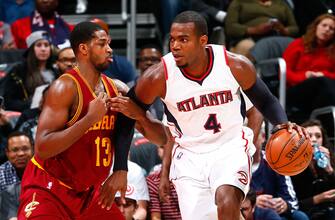 ATLANTA, GA - DECEMBER 30:  Paul Millsap #4 of the Atlanta Hawks drives against Tristan Thompson #13 of the Cleveland Cavaliers at Philips Arena on December 30, 2014 in Atlanta, Georgia.  NOTE TO USER: User expressly acknowledges and agrees that, by downloading and or using this photograph, User is consenting to the terms and conditions of the Getty Images License Agreement.  (Photo by Kevin C. Cox/Getty Images)