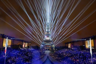 Overview of the Trocadero venue, with the Eiffel Tower looming in the background 
and lasers lighting up the sky, during the opening ceremony of the Paris 2024 Olympic Games on July 26, 2024 (Photo by FranÃ§ois-Xavier MARIT / AFP) (Photo by FRANCOIS-XAVIER MARIT/AFP via Getty Images)