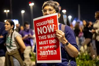 A left-wing protester holds a sign in English that says "ceasfire now" at a demonstration for the kidnapping deal near the Knesset, on March 31, 2024, in Jerusalemm Israel. (Photo by Yahel Gazit / Middle East Images / Middle East Images via AFP) (Photo by YAHEL GAZIT/Middle East Images/AFP via Getty Images)