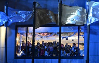 People watch from their window the Rockefeller Center's annual Christmas Tree lighting ceremony in New York, November 29, 2023. (Photo by ANGELA WEISS / AFP) (Photo by ANGELA WEISS/AFP via Getty Images)