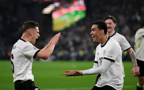 23 March 2025, North Rhine-Westphalia, Dortmund: Soccer: Nations League A, Germany - Italy, play-off round, quarter-finals, second leg, Signal Iduna Park, Germany's Jamal Musiala (r) celebrates after his goal to make it 2-0 with Joshua Kimmich, who provided the assist. Photo: Fabian Strauch/dpa (Photo by Fabian Strauch/picture alliance via Getty Images)
