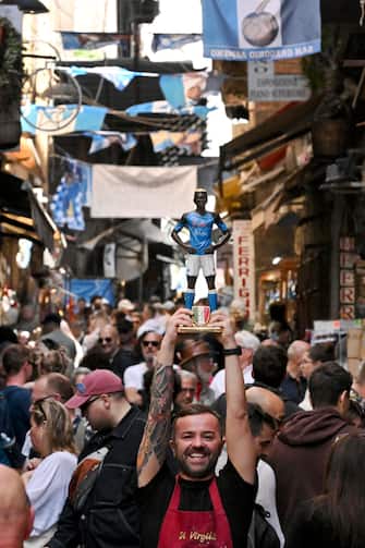 The craftsman of San Gregorio Armeno Genny Di Virgilio cheers, for the imminent celebrations of the Scudetto, with a terracotta statue he made of the Napoli striker Victor Osimhen, in Naples, Italy, 28 April 2023. SSC Napoli lead the Serie A, continuing their seemingly unstoppable march towards the title. ANSA / CIRO FUSCO