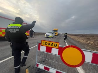 GRINDAVIK, ICELAND - NOVEMBER 14: Police direct traffic out of Grindavik on November 14, 2023 in Grindavik, Iceland.  For the second day residents were allowed in to quickly collect personal belongings. (Photo by Micah Garen/Getty Images)