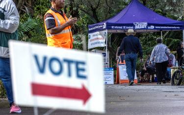 epa11673346 A sign reads 'Vote' next to a secure ballot intake station on Florida's first early voting day for the 2024 US presidential election at the Coral Gables regional library in Miami, Florida, USA, 21 October 2024. Voters in Florida can cast their ballots in person for the presidential election, starting on 21 October, avoiding long lines on Election Day on 05 November 2024.  EPA/CRISTOBAL HERRERA-ULASHKEVICH