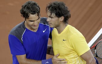 epa02722085 Spanish tennis player Rafael Nadal (R) is congratulated by Swiss Roger Federer after winning during their Mutua Madrid Open semifinal match at the Caja Magica tennis premises in Madrid, Spain, 07 May 2011. Nadal won 5-7, 6-1 and 6-3.  EPA/JUANJO MARTIN