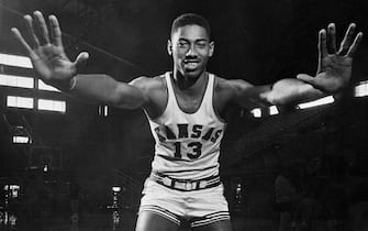 (Original Caption) Wilt "The Stilt" Chamberlain, 7-foot Kansas Center, displays the mitts which have deflected 127 enemy shots during Kansas' first twenty games this season.Wilt's hands measure 9 1/2 inches from wrist to tip of middle finger and 11 1/2 inches from spread thumb to spread little finger. Thus far Chamberlain has blocked potential of 254 points, or, as Kansas opponents are shooting 35 cents, 88.9 points.Wilt is ranked first nationally in rebounds at 26 per cent,running 3rd nationally in scoring 29.20 average.