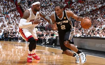 MIAMI, FL - JUNE 12: Kawhi Leonard #2 of the San Antonio Spurs drives against LeBron James #6 of the Miami Heat during Game Four of the 2014 NBA Finals at American Airlines Arena in Miami, Florida on June 12, 2014.  NOTE TO USER: User expressly acknowledges and agrees that, by downloading and or using this photograph, User is consenting to the terms and conditions of the Getty Images License Agreement. Mandatory Copyright Notice: Copyright 2014 NBAE  (Photo by Nathaniel S. Butler/NBAE via Getty Images)