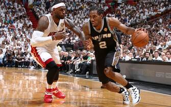 MIAMI, FL - JUNE 12: Kawhi Leonard #2 of the San Antonio Spurs drives against LeBron James #6 of the Miami Heat during Game Four of the 2014 NBA Finals at American Airlines Arena in Miami, Florida on June 12, 2014.  NOTE TO USER: User expressly acknowledges and agrees that, by downloading and or using this photograph, User is consenting to the terms and conditions of the Getty Images License Agreement. Mandatory Copyright Notice: Copyright 2014 NBAE  (Photo by Nathaniel S. Butler/NBAE via Getty Images)